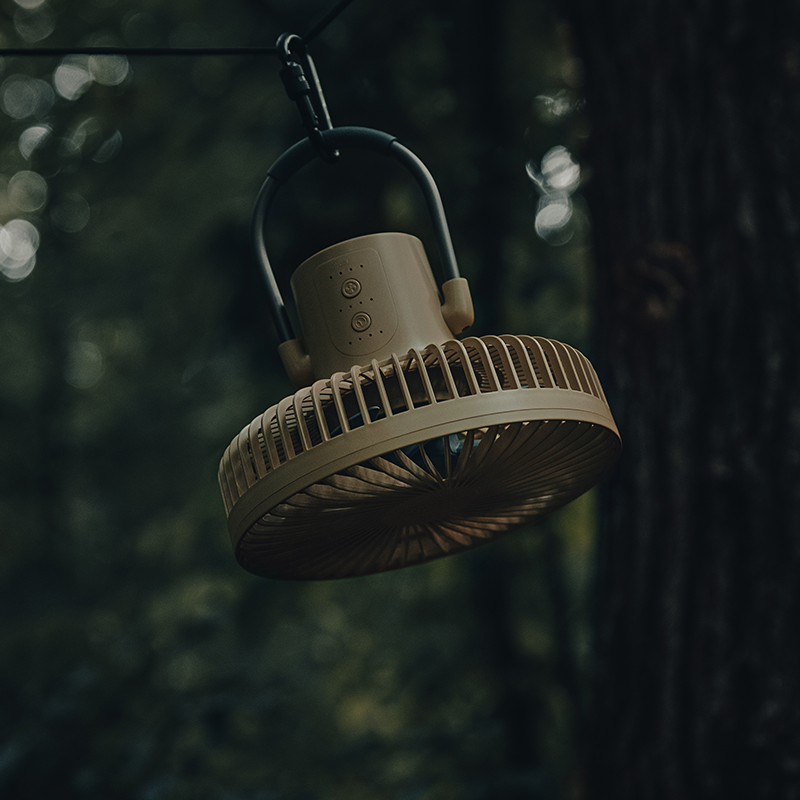 camping fan hanging under tarp shelter