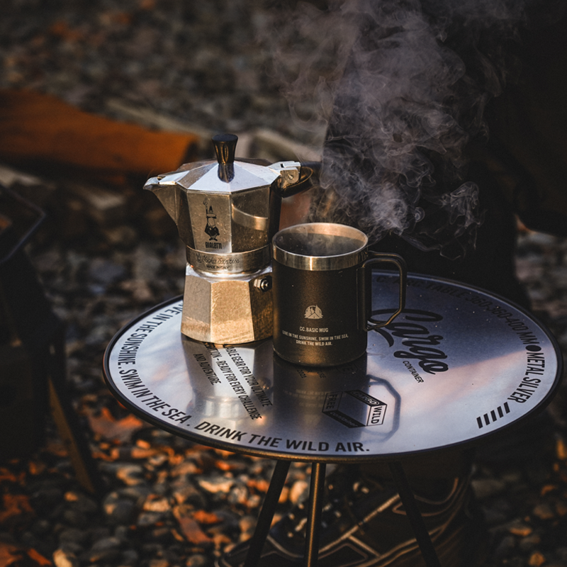 Portable camping table used as a camp kitchen for outdoor cooking