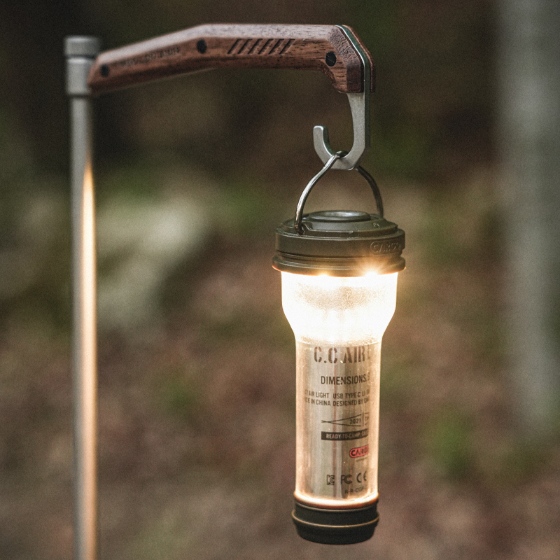 Rechargeable camping light creating warm ambient lighting around a campsite
